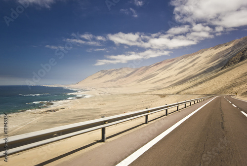 highway in chilean desert through the coast line photo