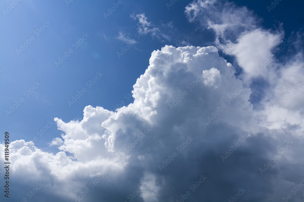 Edges of storm clouds illuminated by the sun on a background of blue sky Edges of storm clouds illuminated by the sun on a background of blue sky