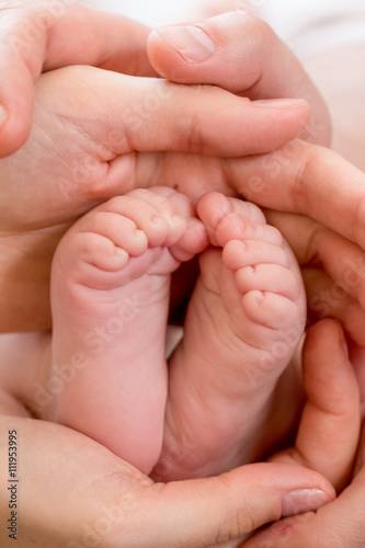 baby foot in the hands of parents