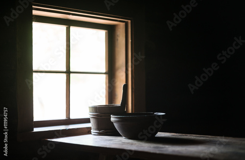 Wooden table with dishes in ancient house.
