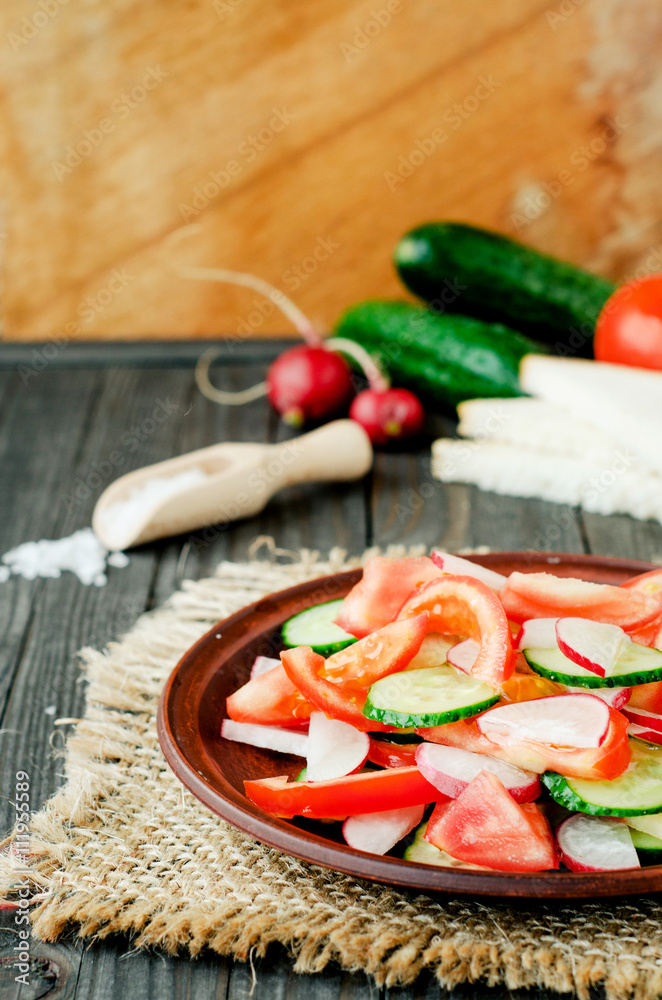 healthy salad with fresh ripe summer vegetables , tomato, cucumber , radishes , spices and white toast on a wooden background
healthy salad with fresh ripe summer vegetables , tomato, cucumber , radishes , spices and white toast on a wooden background