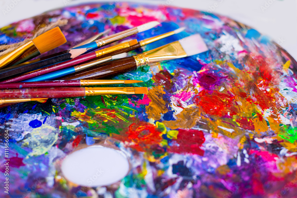 oil paints and paint brushes on a palette