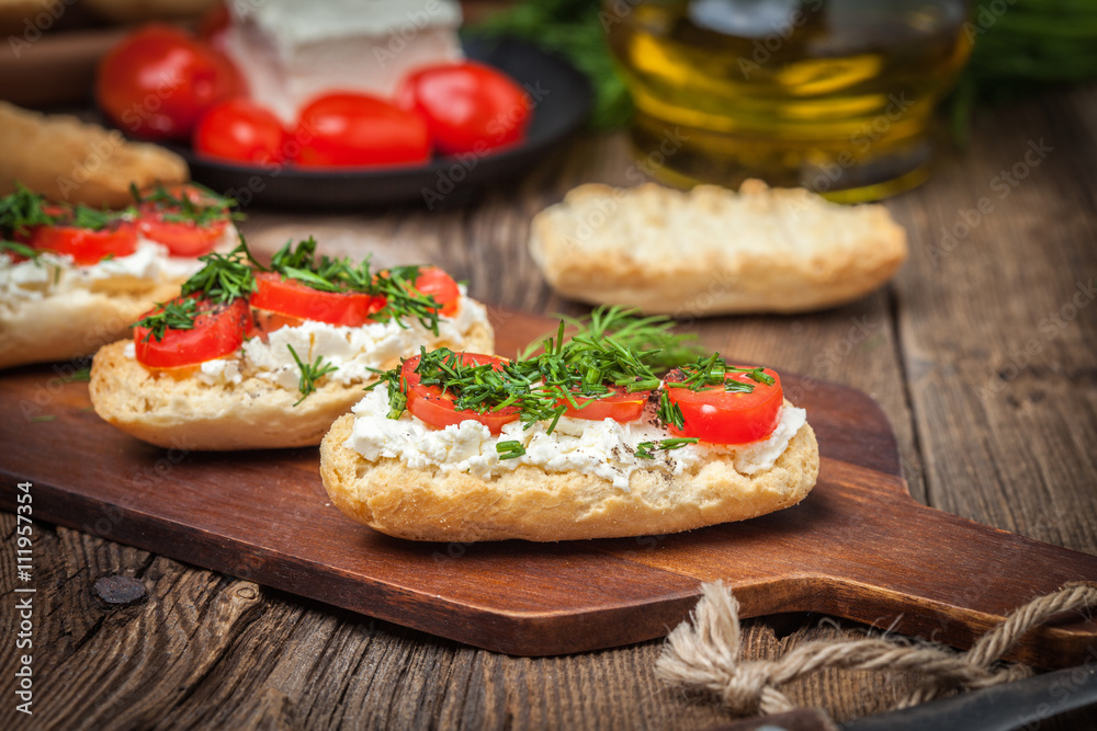 Delicious bruschetta with tomatoes, feta cheese, dill and spice Delicious bruschetta with tomatoes, feta cheese, dill and spice