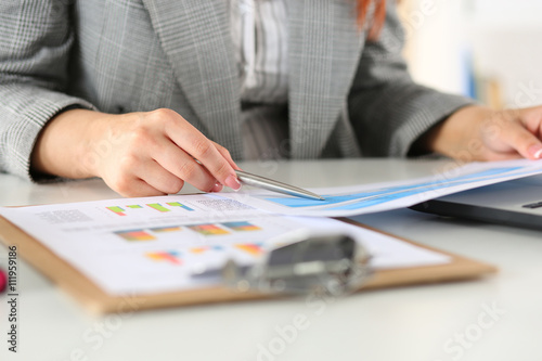 Businesswoman looking at graphics photo