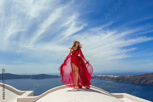 Woman in red dress on the roof © Santorines