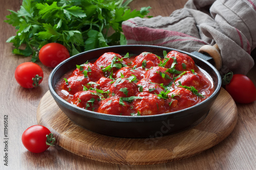 Meatballs in tomato sauce / Delicious homemade chicken or turkey meatballs with rice, vegetable in tomato sauce photo