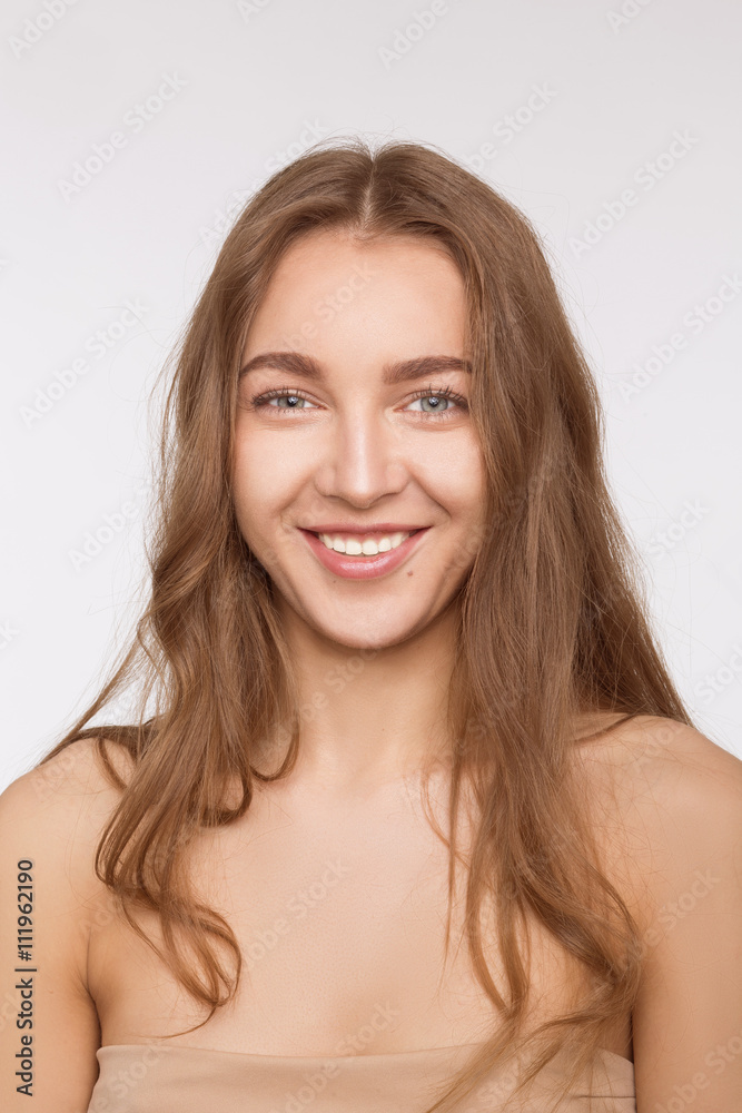 Portrait of toothy smiling beautiful model lady over white background in studio. Happy woman looking at camera and smiling. Portrait of toothy smiling beautiful model lady over white background in studio. Happy woman looking at camera and smiling.