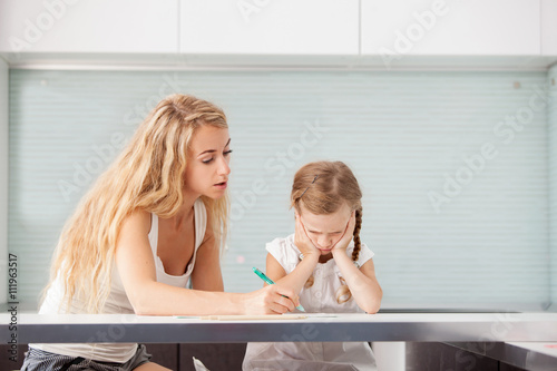 Parent helps the child to do homework