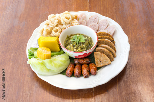 Hors d'oeuvres food Northern style tradition Thai cuisine menu with herbs fried sausage, pork, boiled cabbage, boiled pumpkin, sour pork, chili youth delicious food in Chiang mai province Thailand.