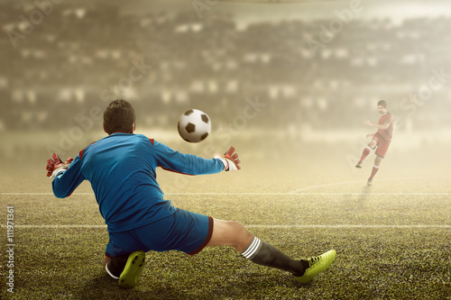 Man kick ball on the goalkeeper