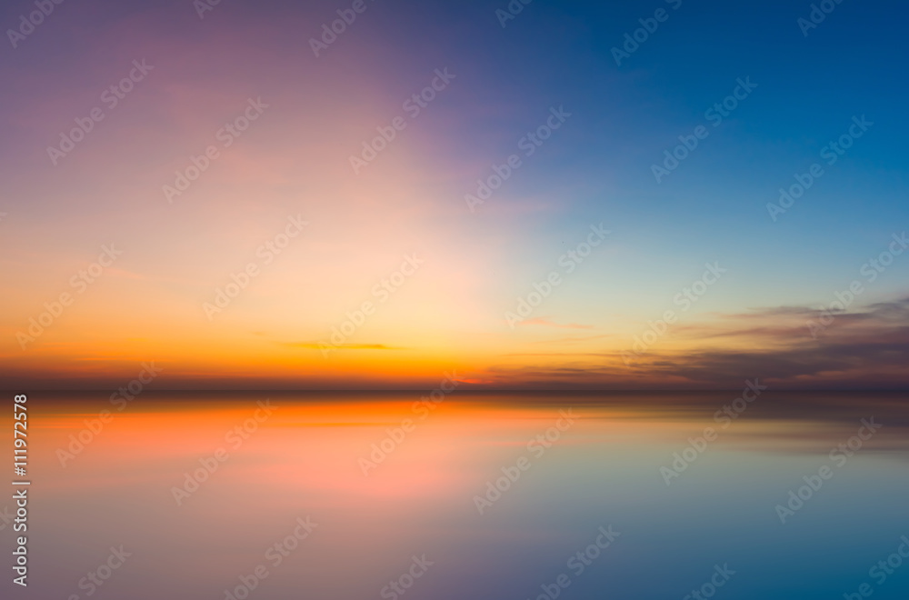 Colorful evening sunset with cloud in the sky reflect on sea. Tw