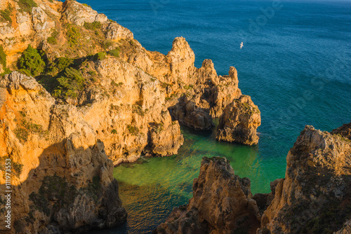Beautiful bay with rocks and turquoise water at the coast of Portimao. Algarve region. Portugal © alexanderkonsta