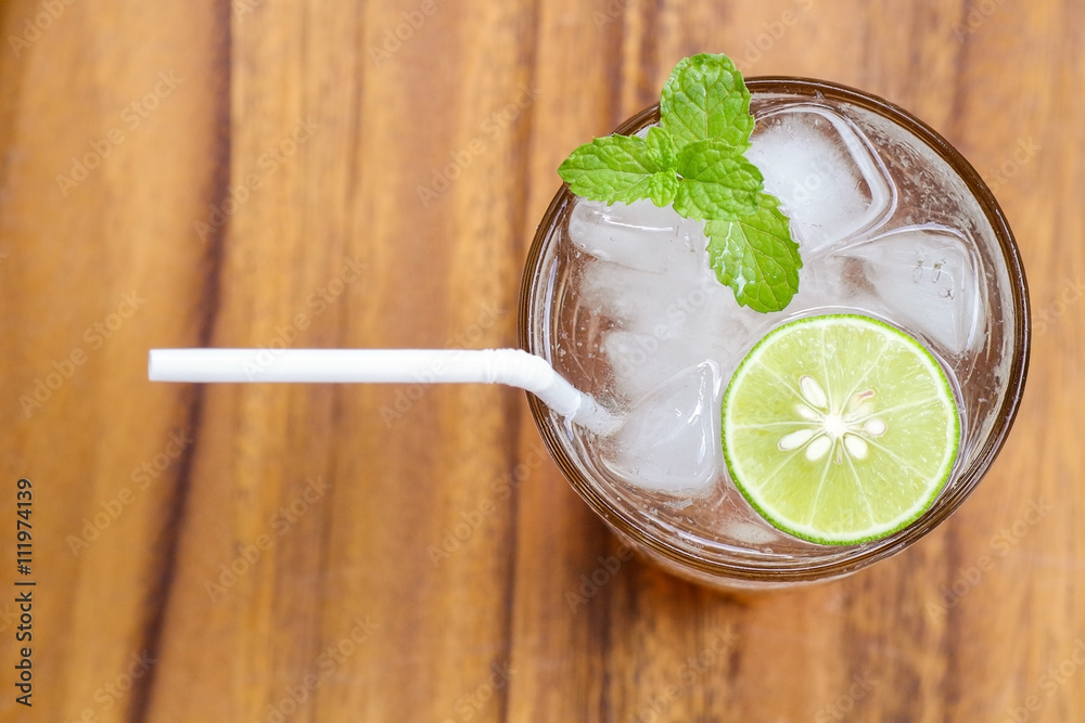Top view of fresh cocktail with lime slice and mint on wood back Top view of fresh cocktail with lime slice and mint on wood back