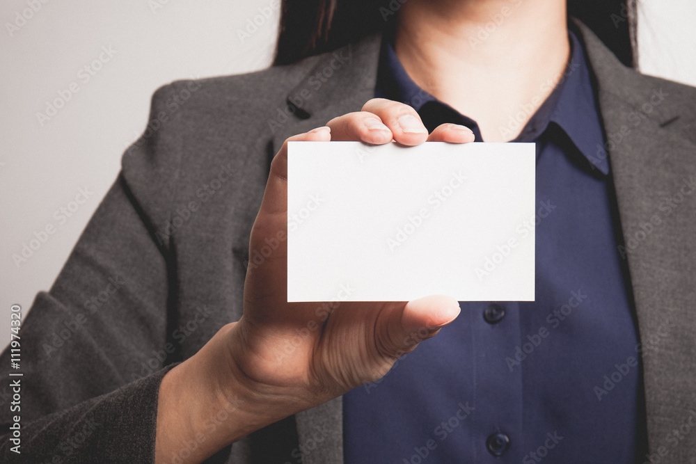 Businesswoman showing and handing a blank business card. Businesswoman showing and handing a blank business card.