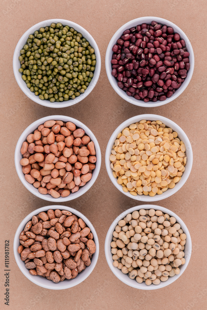 Assortment of beans and lentils in wooden spoon isolate on white Assortment of beans and lentils in wooden spoon isolate on white