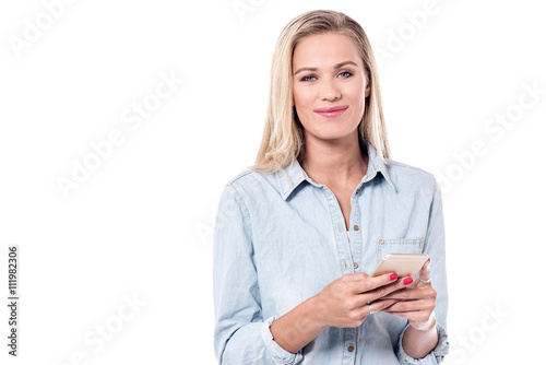 Young woman typing text in smart phone.