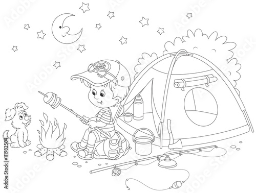 Little boy scout roasting bread on campfire near his camping tent
