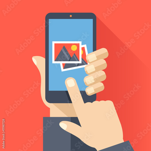 Hand holds smartphone with photos icon on smartphone screen. Multimedia, photo album app concept. Creative flat design vector illustration