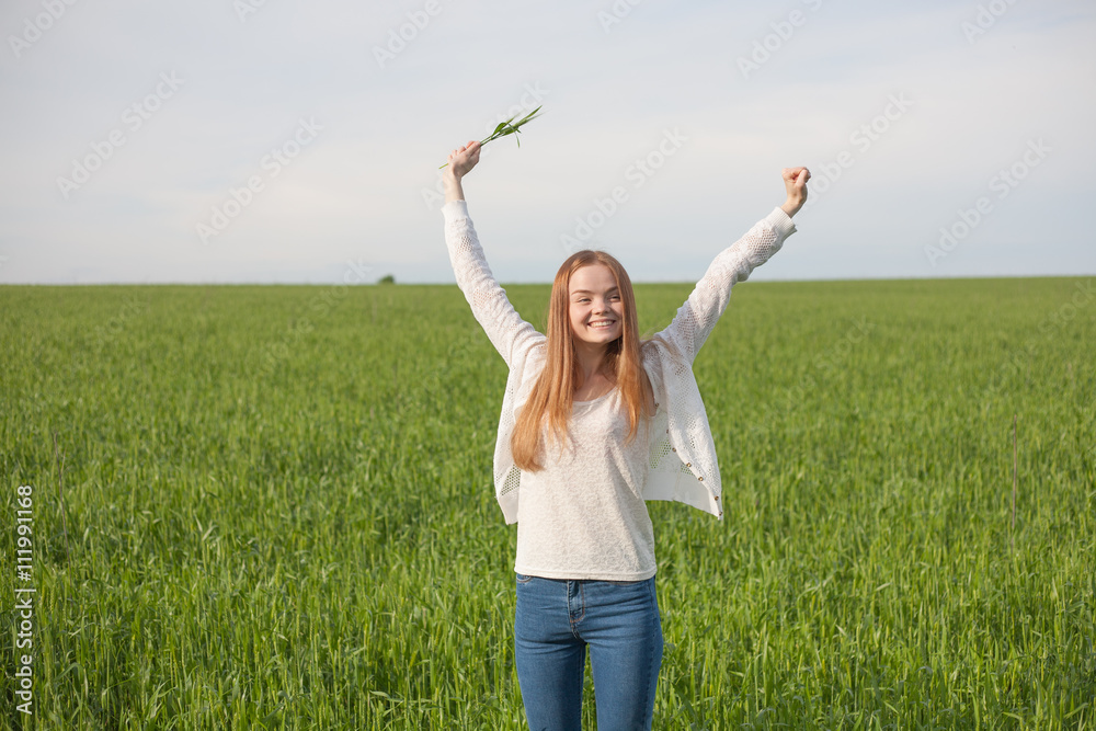 woman with open arms in the green wheat field at the morning. woman with open arms in the green wheat field at the morning.