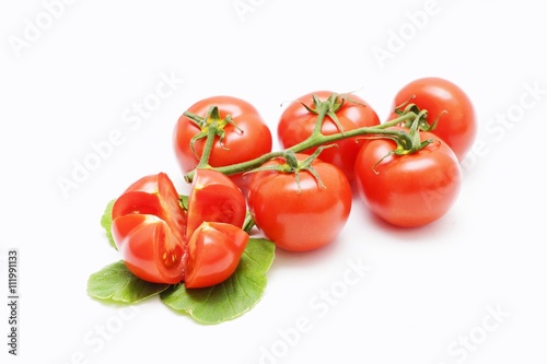 Fresh red organic tomatoes on a white background