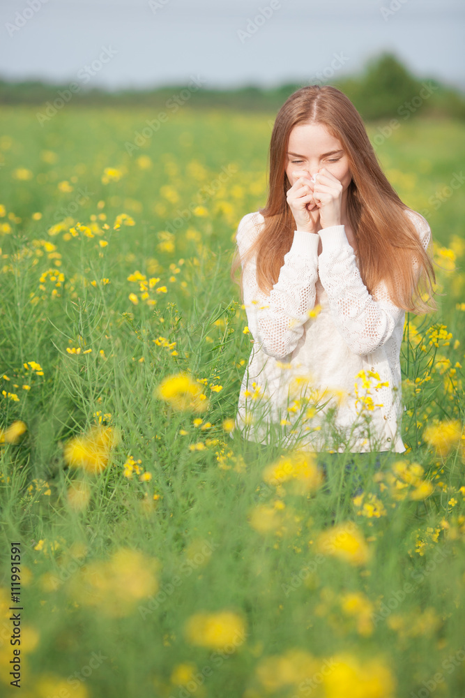 Pollen allergy, girl sneezing in a field of flowers. Pollen allergy, girl sneezing in a field of flowers.