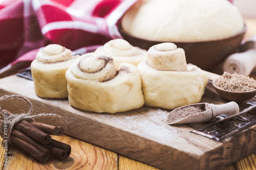 Making cinnamon buns. Homemade yeast dough after raising Making cinnamon buns. Homemade yeast dough after raising
