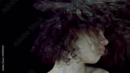 Young long haired man dancing and nodding to the music
