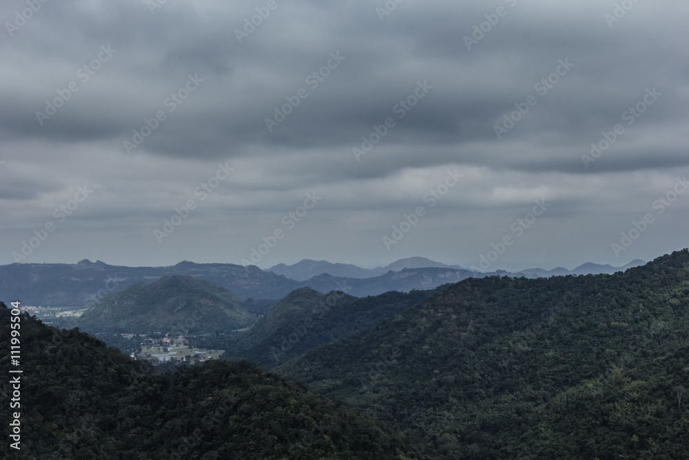 mountain peak landscape with clouds and rain.