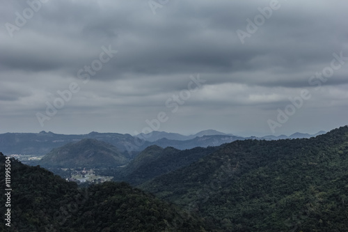 mountain peak landscape with clouds and rain.