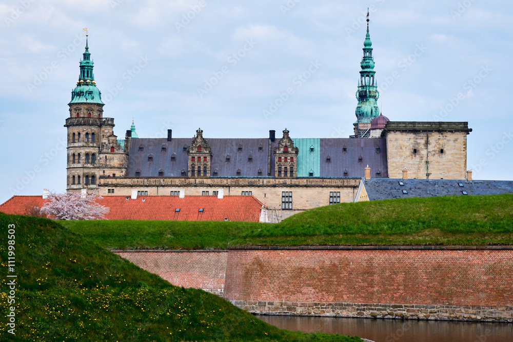 Elsinore castle in Denmark seen from the other side of the moat with vertical red brick walls