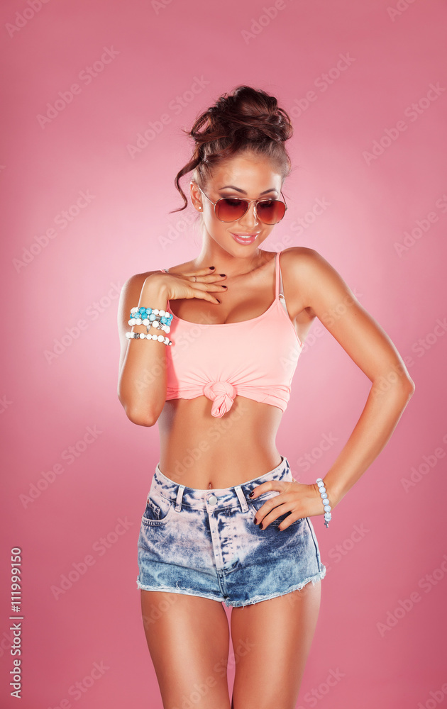 Fototapeta premium Model in pink shirt and jeans shorts