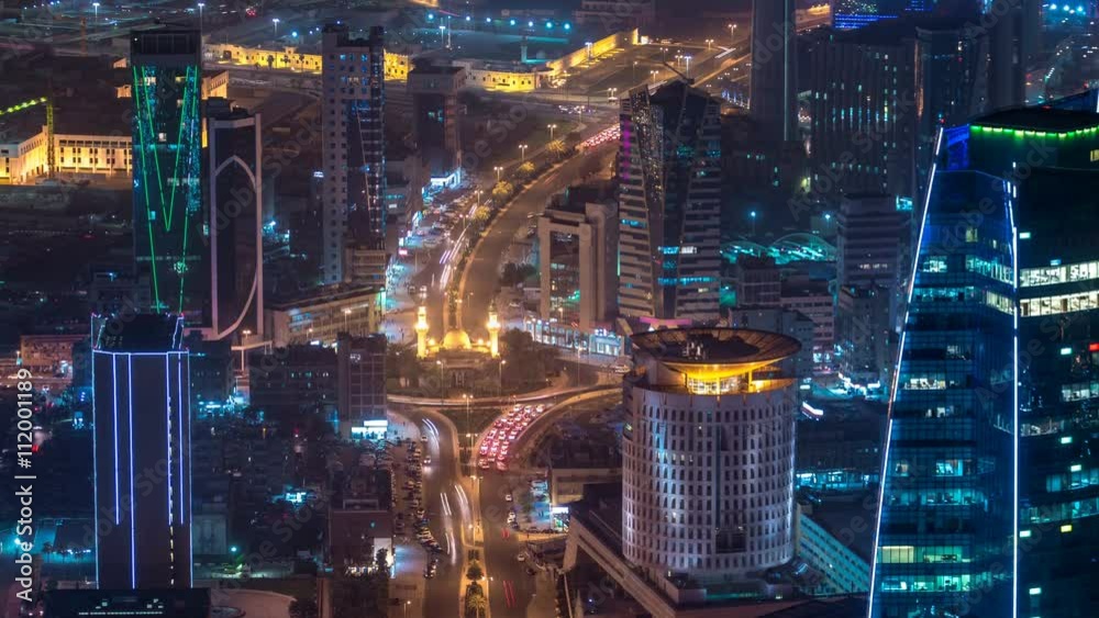 Skyline with Skyscrapers night timelapse in Kuwait City downtown illuminated at dusk. Kuwait City, Middle East Skyline with Skyscrapers night timelapse in Kuwait City downtown illuminated at dusk. Kuwait City, Middle East
