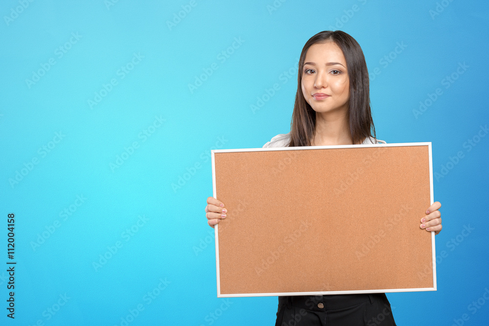 Smiling casual woman holding the empty corkboard Smiling casual woman holding the empty corkboard