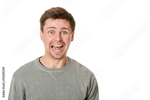 Konstfotografi Happy young man with manic expression, on gray background