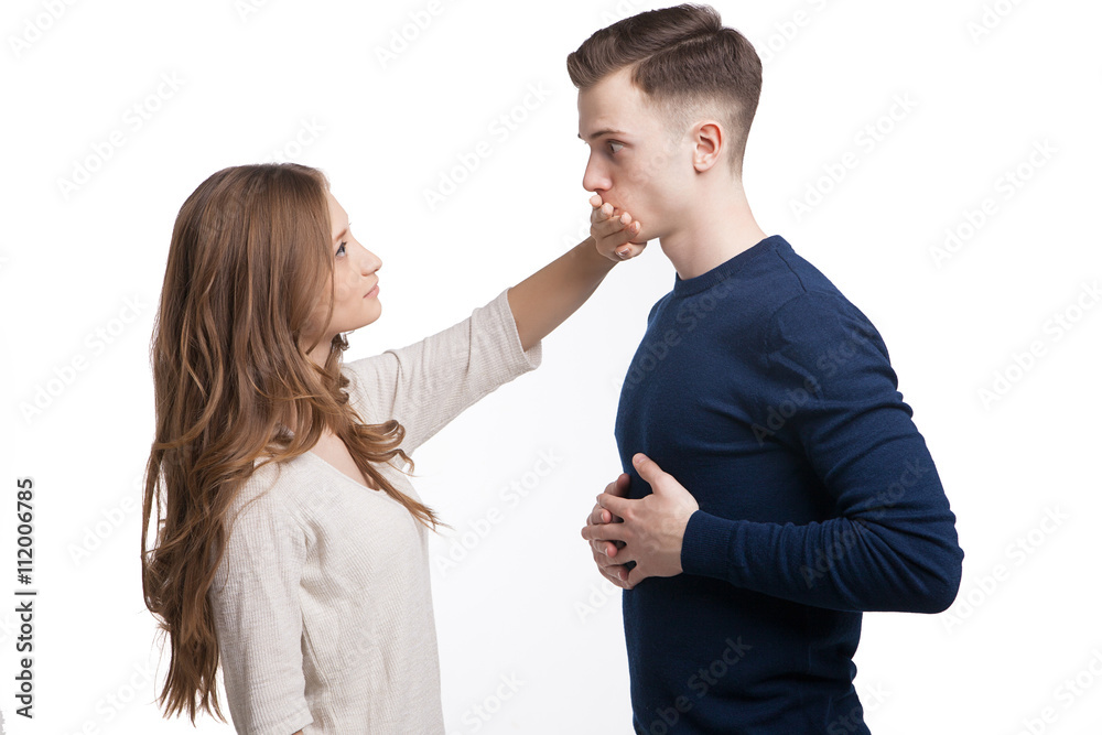 Side view of girl covering man's mouth with hand