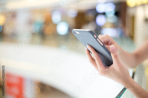 Woman sending sms on cell phone