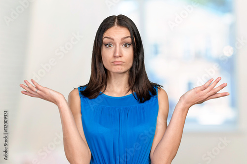 Unhappy young woman with questionable gesture