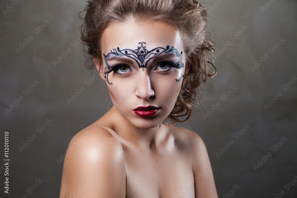 Beautiful model with face art looking at camera Beautiful model with face art looking at camera