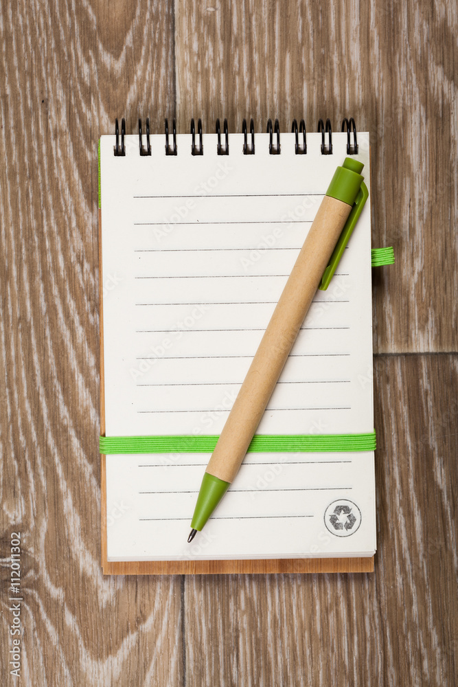 Blank note paper with pen on wood background Blank note paper with pen on wood background
