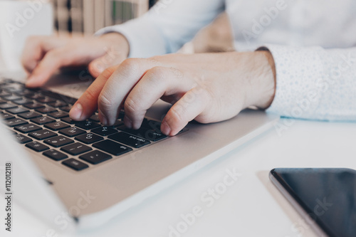 Businessman at work. Close-up top view of man working on laptop