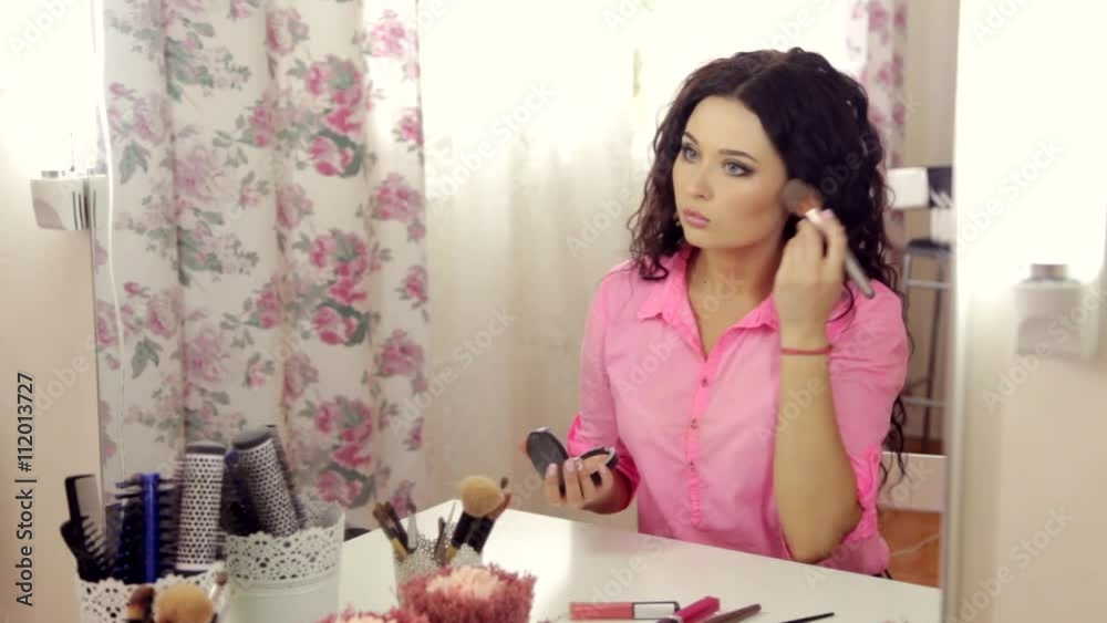 Woman makeup looking at the mirror HD Woman makeup looking at the mirror HD