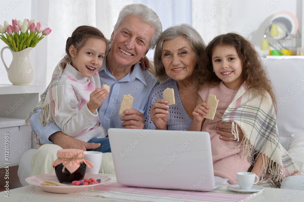 senior couple with grandchildren and laptop senior couple with grandchildren and laptop