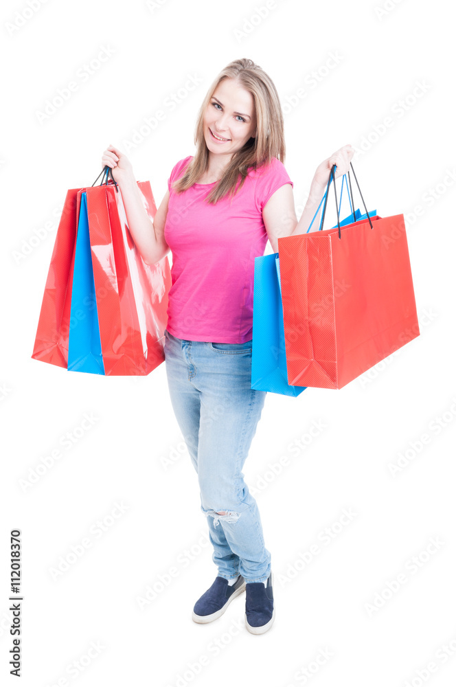 Shopaholic young girl holding shopping bags in both hands Shopaholic young girl holding shopping bags in both hands