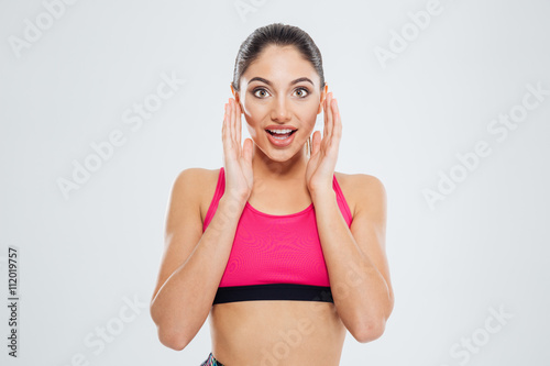 Amazed fitness woman looking at camera