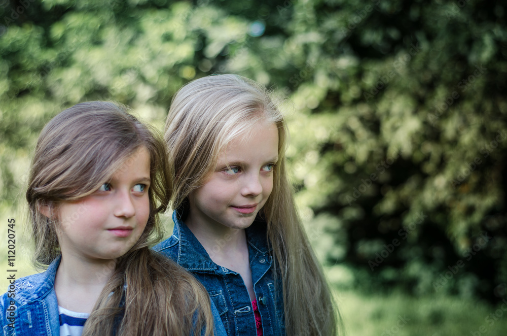 Portrait of two cute little girls enjoying summer outdoors. Portrait of two cute little girls enjoying summer outdoors.