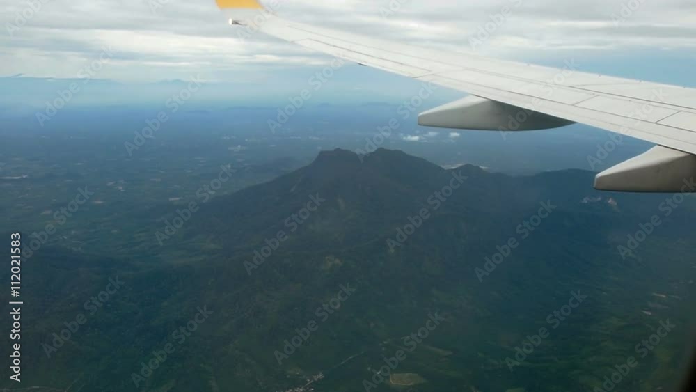 Wing of airplane and view through plane window.
Wing of airplane and view through plane window.