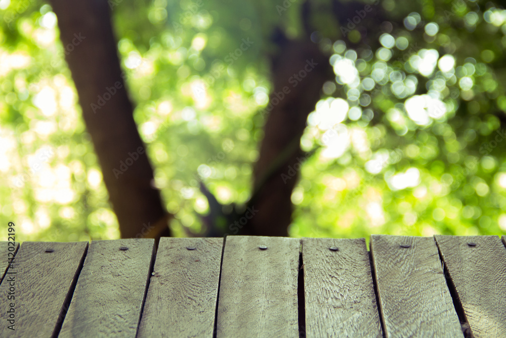 empty old wooden with green bokeh in garden