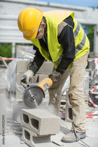 Worker sawing the air block. 