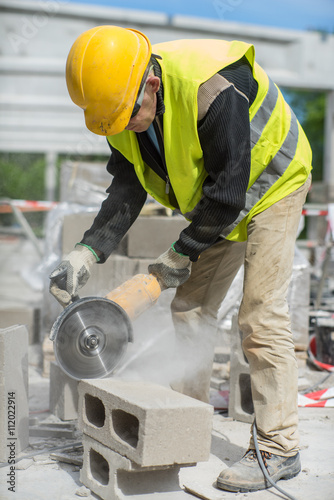 Worker sawing the air block. 