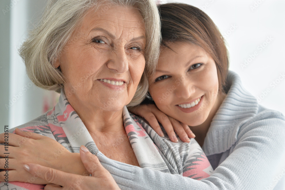 cheerful mother and adult daughter cheerful mother and adult daughter